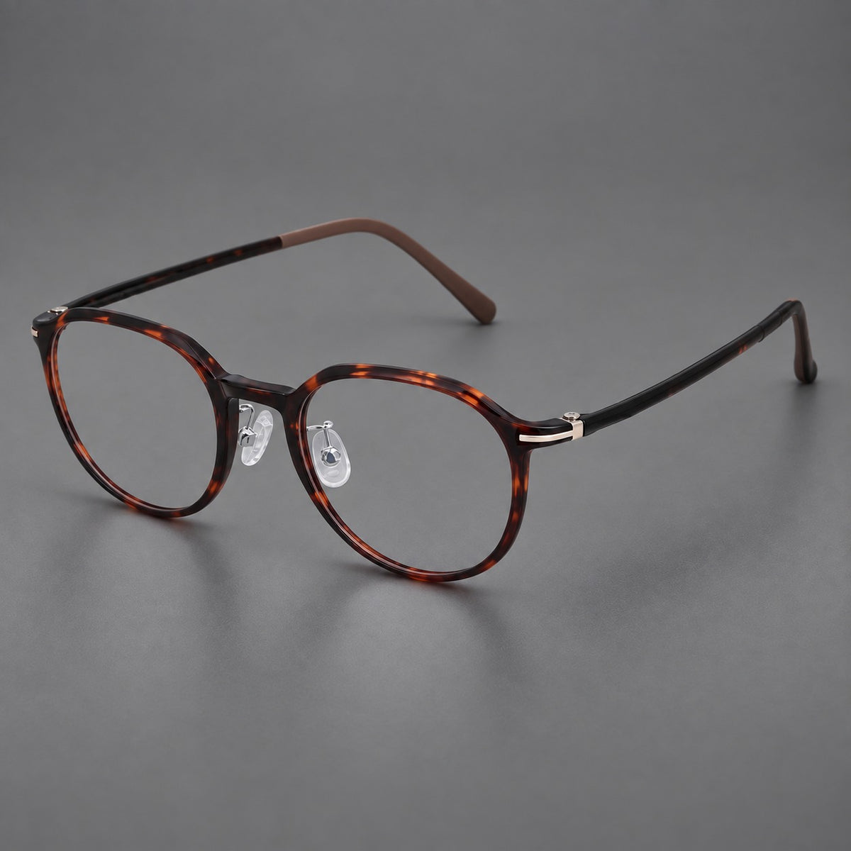 Retro round plastic eyeglasses with a curved bridge and slim metal corner accents in Tortoiseshell, three quarter view