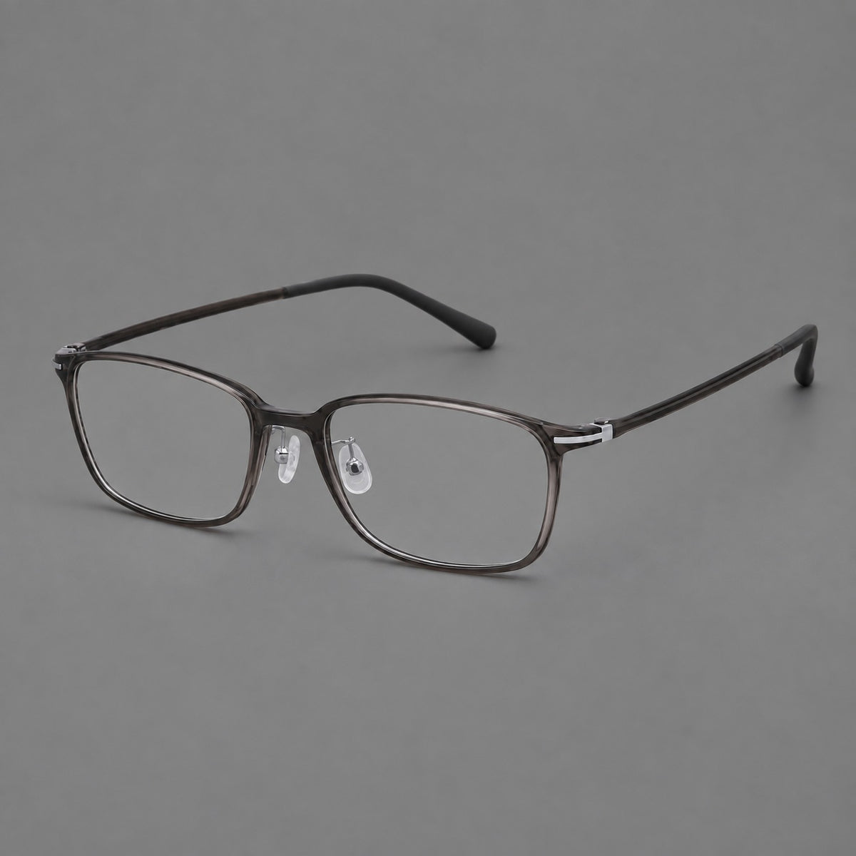 Low profile rectangular plastic eyeglasses with a straight browline and slim temples in Dark Grey, three quarter view