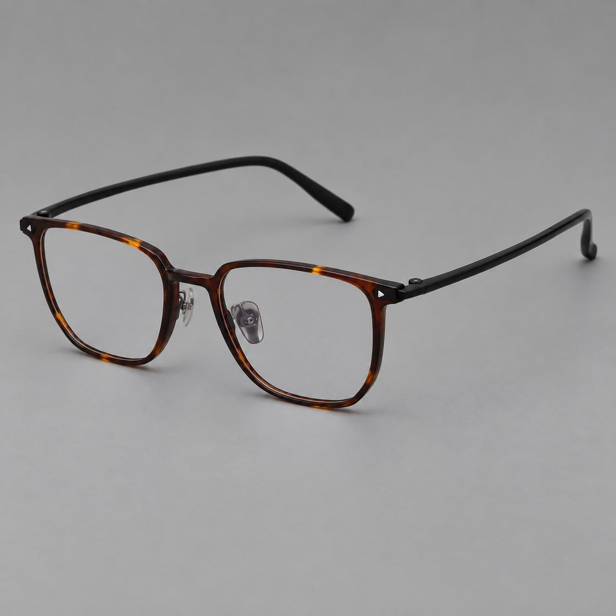 Refined rectangular plastic eyeglasses with raised outer corners and clear nose pads in Tortoiseshell, three quarter view