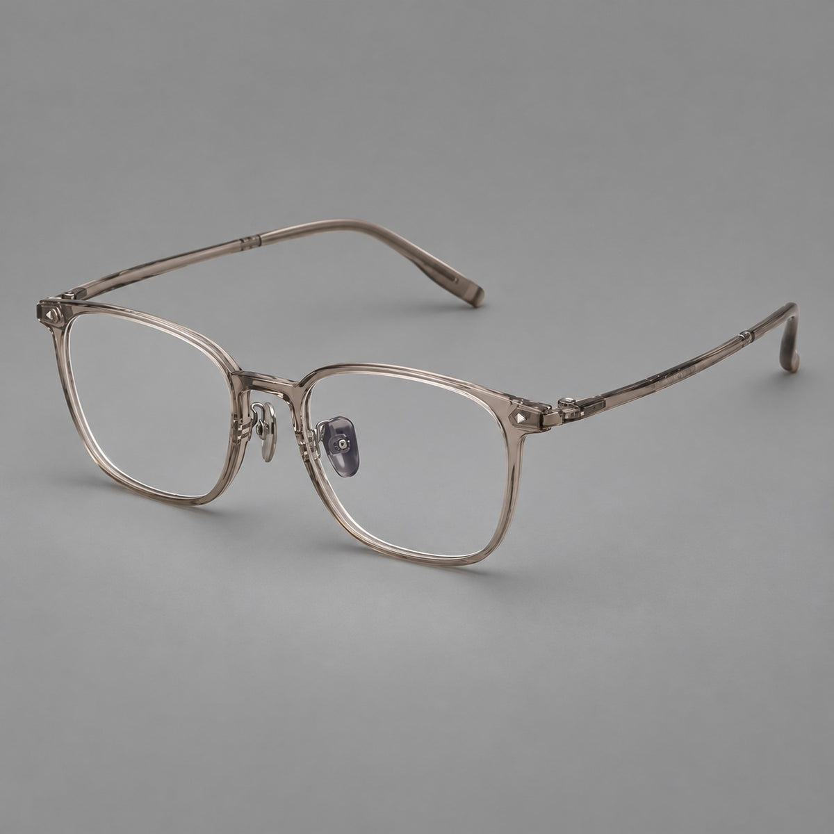 Classic soft square plastic eyeglasses with a gently curved browline and corner studs in Grey Brown, three quarter view