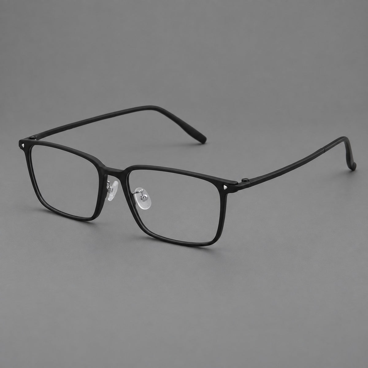 Wide rectangular plastic eyeglasses with an angular browline and slender rims in Matte Black, three quarter view