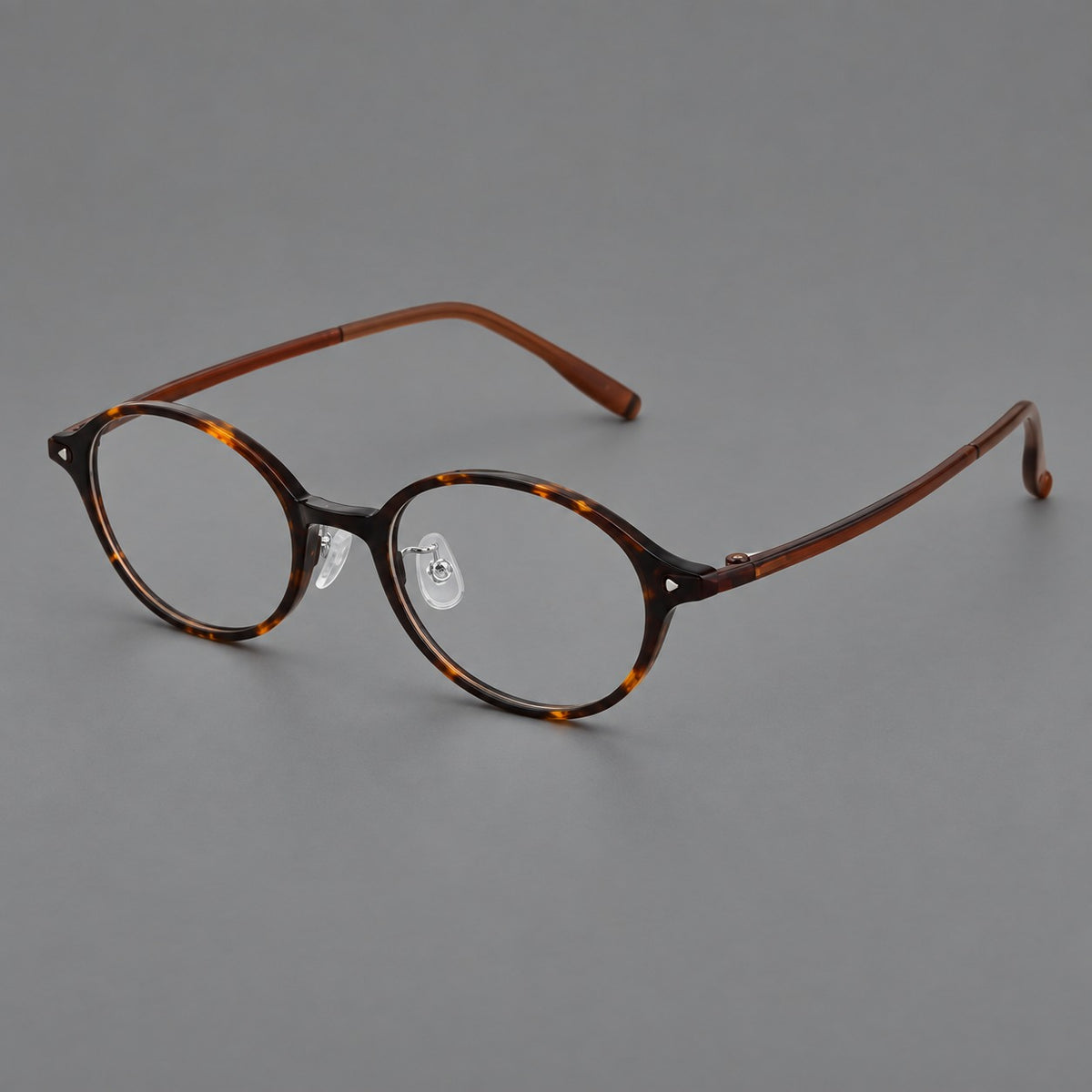 Retro round plastic eyeglasses with softly lifted corners and a sculpted bridge in Tortoiseshell, three quarter view