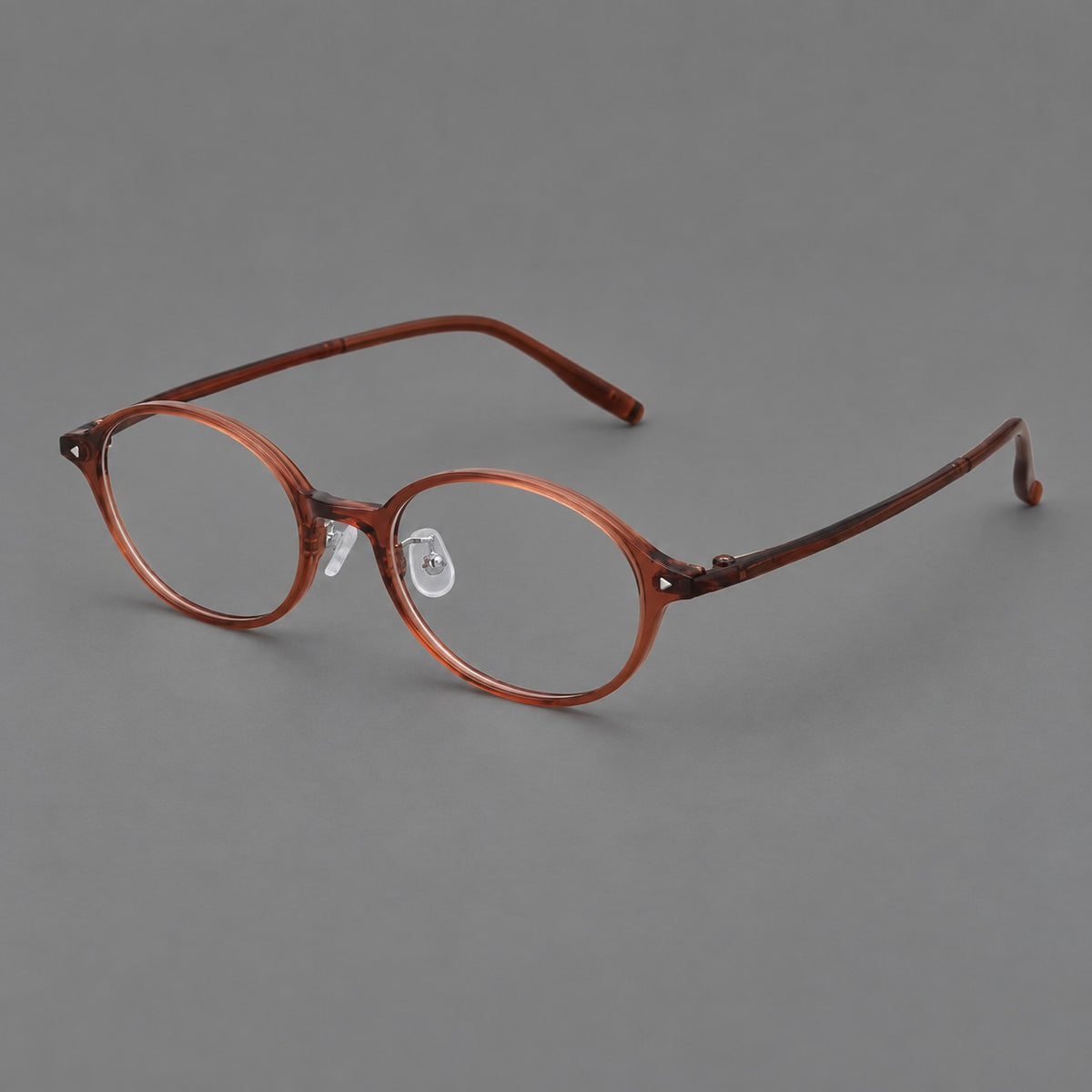 Retro round plastic eyeglasses with softly lifted corners and a sculpted bridge in Brown Red, three quarter view