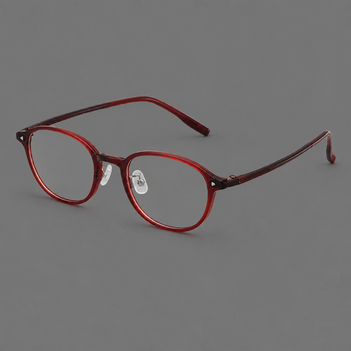 Panto plastic eyeglasses with a rounded silhouette and triangular corner studs in Burgundy, three quarter view