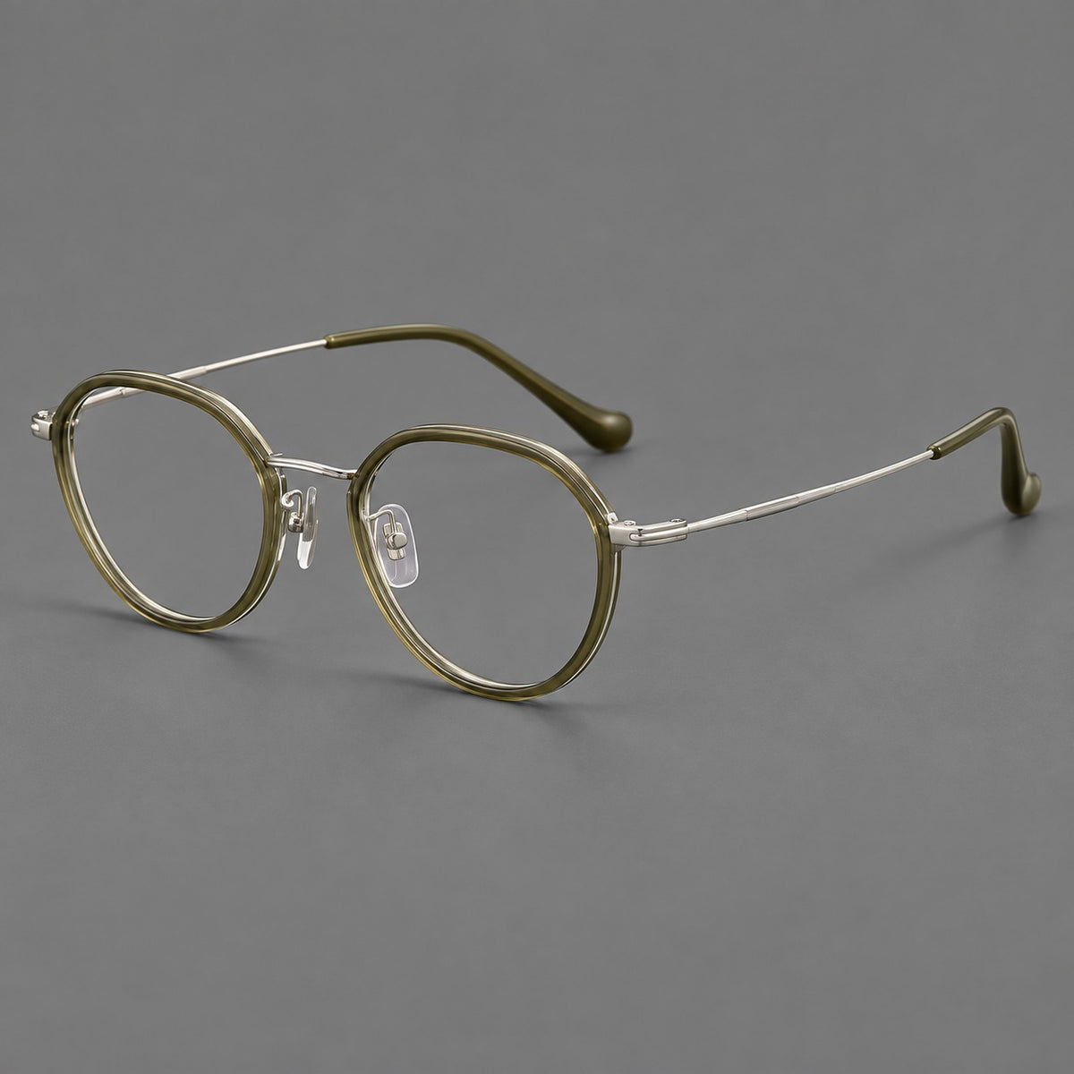 Rounded eyeglasses in acetate and titanium with gently arched brows and engraved metal temples in Grey Green / Silver, three quarter view