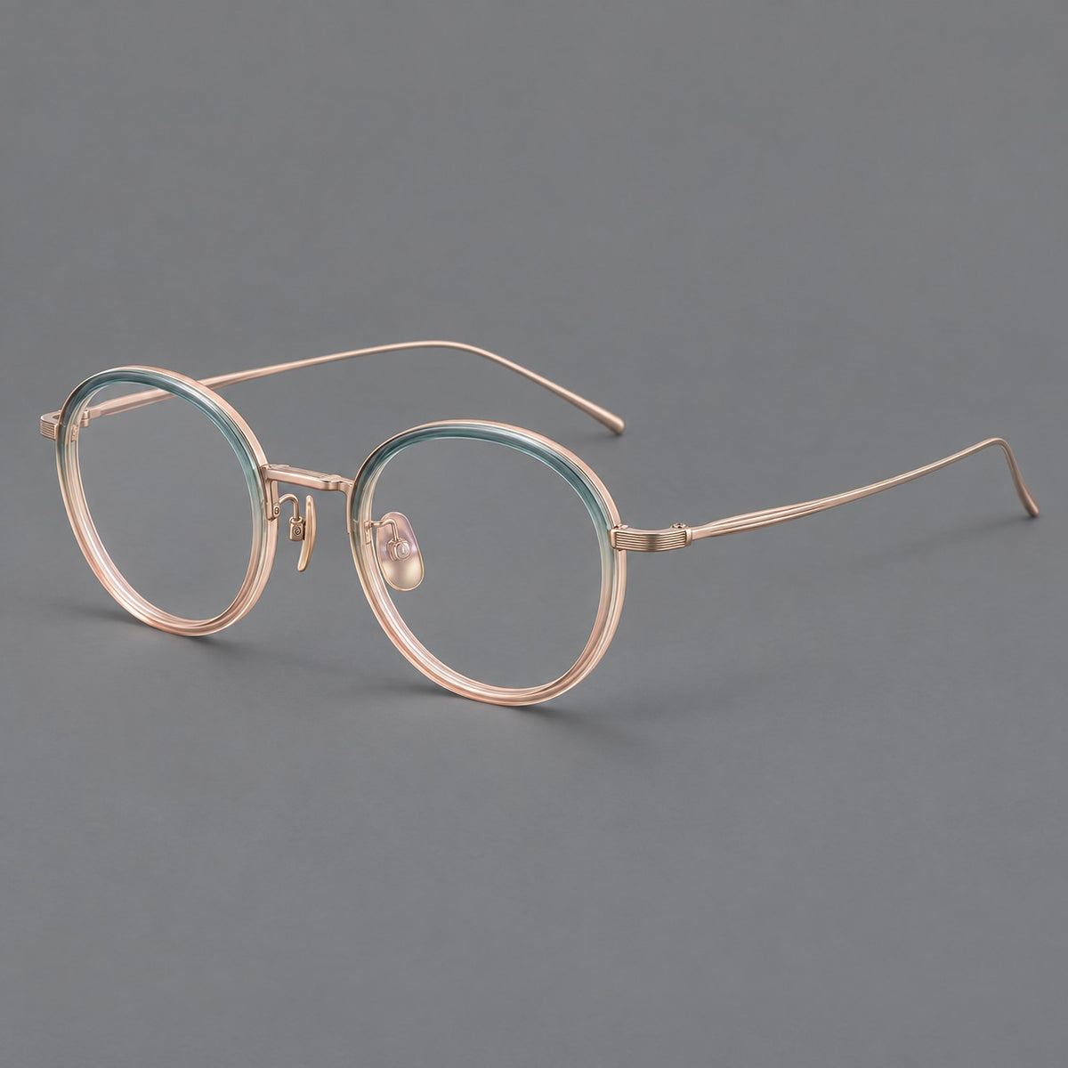 Classic round eyeglasses in acetate and titanium with slim rims and textured metal temples in Blue Tea Gradient / Rose Gold, three quarter view
