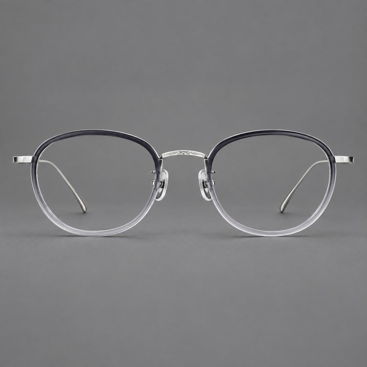 Vintage round eyeglasses in acetate and titanium with an engraved bridge and slender temples in Grey Gradient / Silver, front view