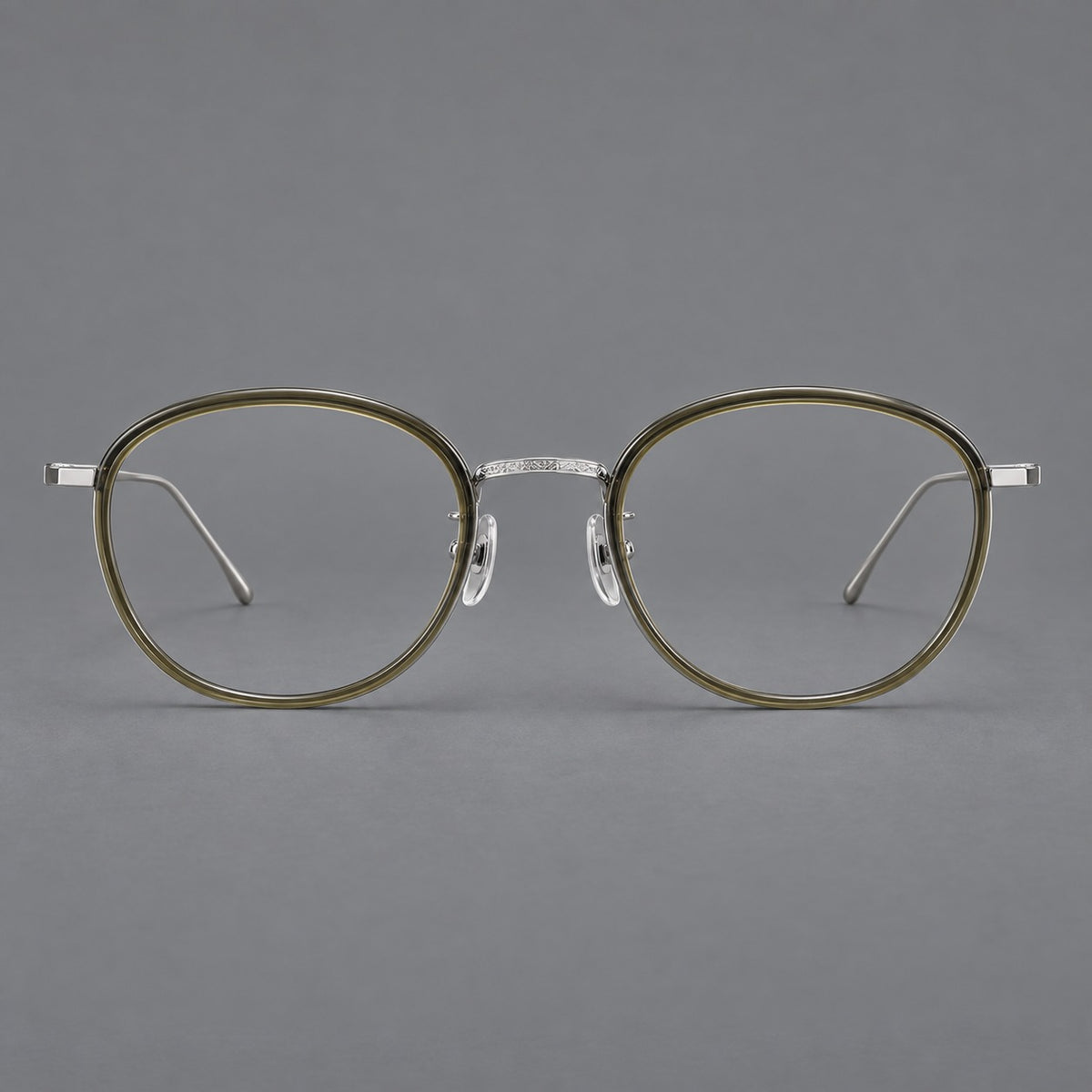 Vintage round eyeglasses in acetate and titanium with an engraved bridge and slender temples in Tea Green / Matte Silver, front view