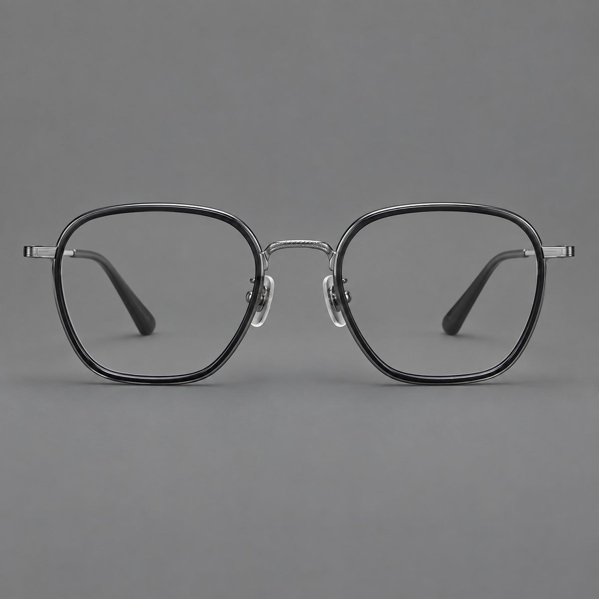 Soft square eyeglasses in acetate and titanium with slim rims and a finely engraved metal bridge in Glossy Black / Gunmetal, front view
