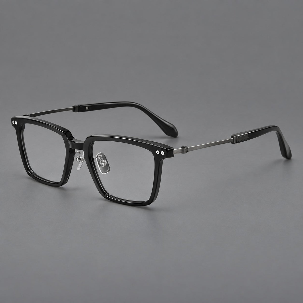 Classic acetate and titanium eyeglasses with a straight brow and rounded rectangular rims in Black / Brushed Grey, three quarter view