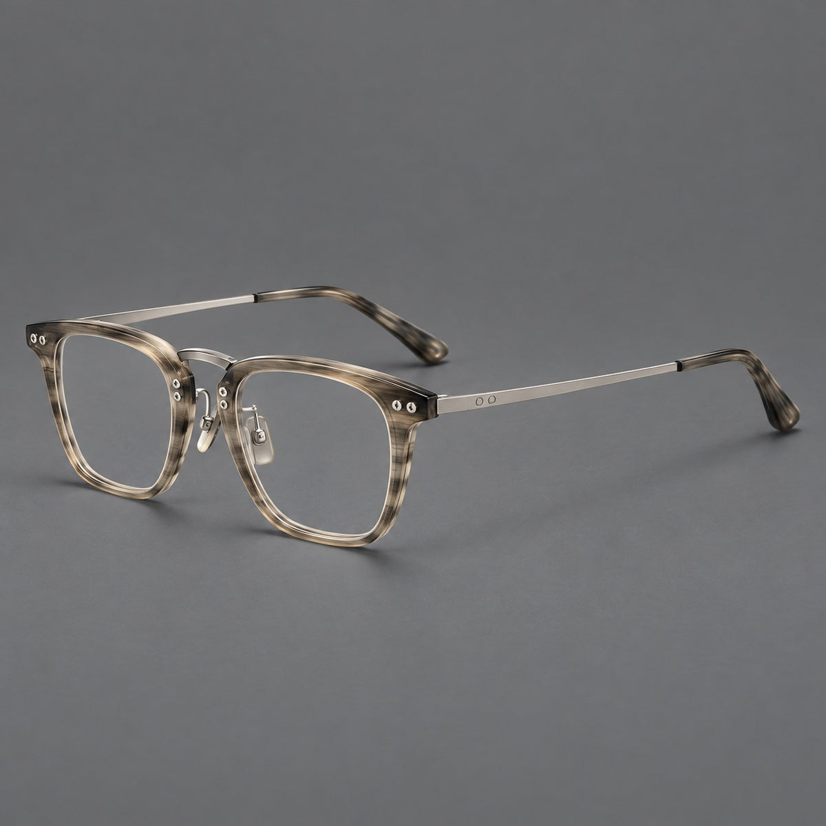 Acetate and titanium eyeglasses with soft square rims and an arched metal bridge in Grey Woodgrain / Silver, three quarter view