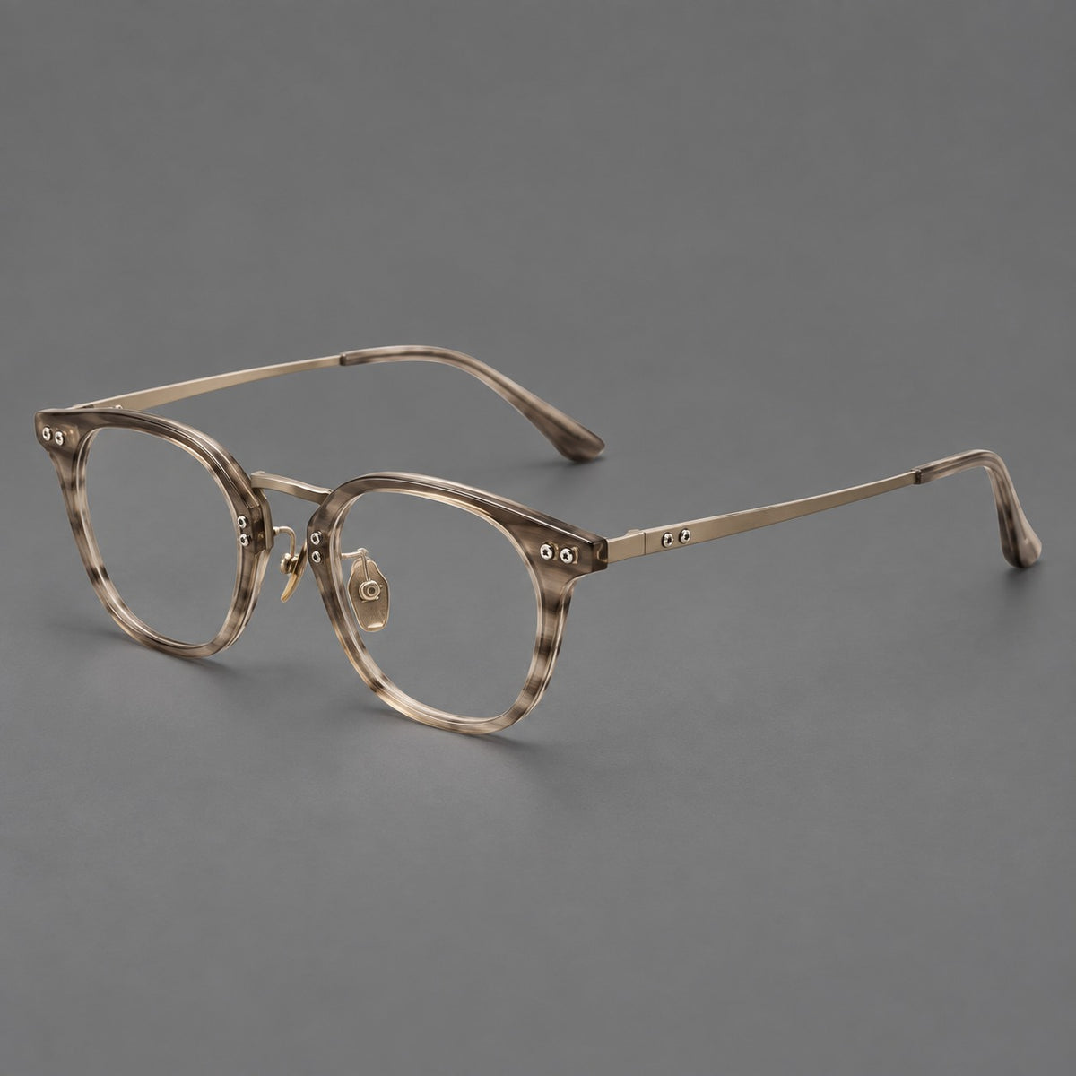 Retro acetate and titanium eyeglasses with softly rounded rims and a metal bridge in Light Grey Woodgrain, three quarter view