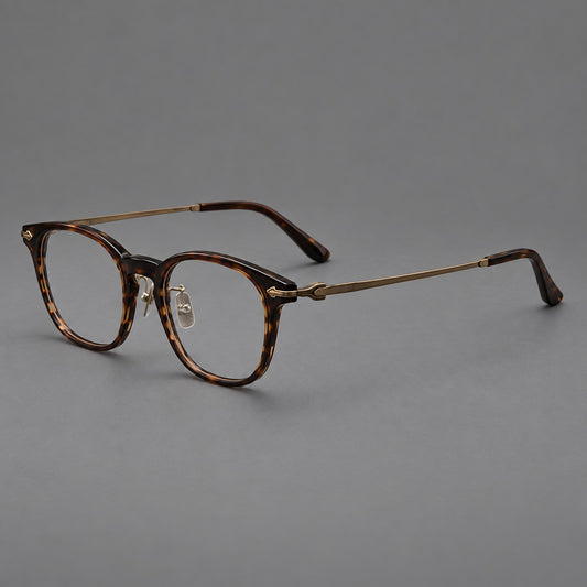 Vintage acetate and titanium eyeglasses with oval rims and decorative metal arrow accents in Tea Woodgrain / Antique Bronze, three quarter view