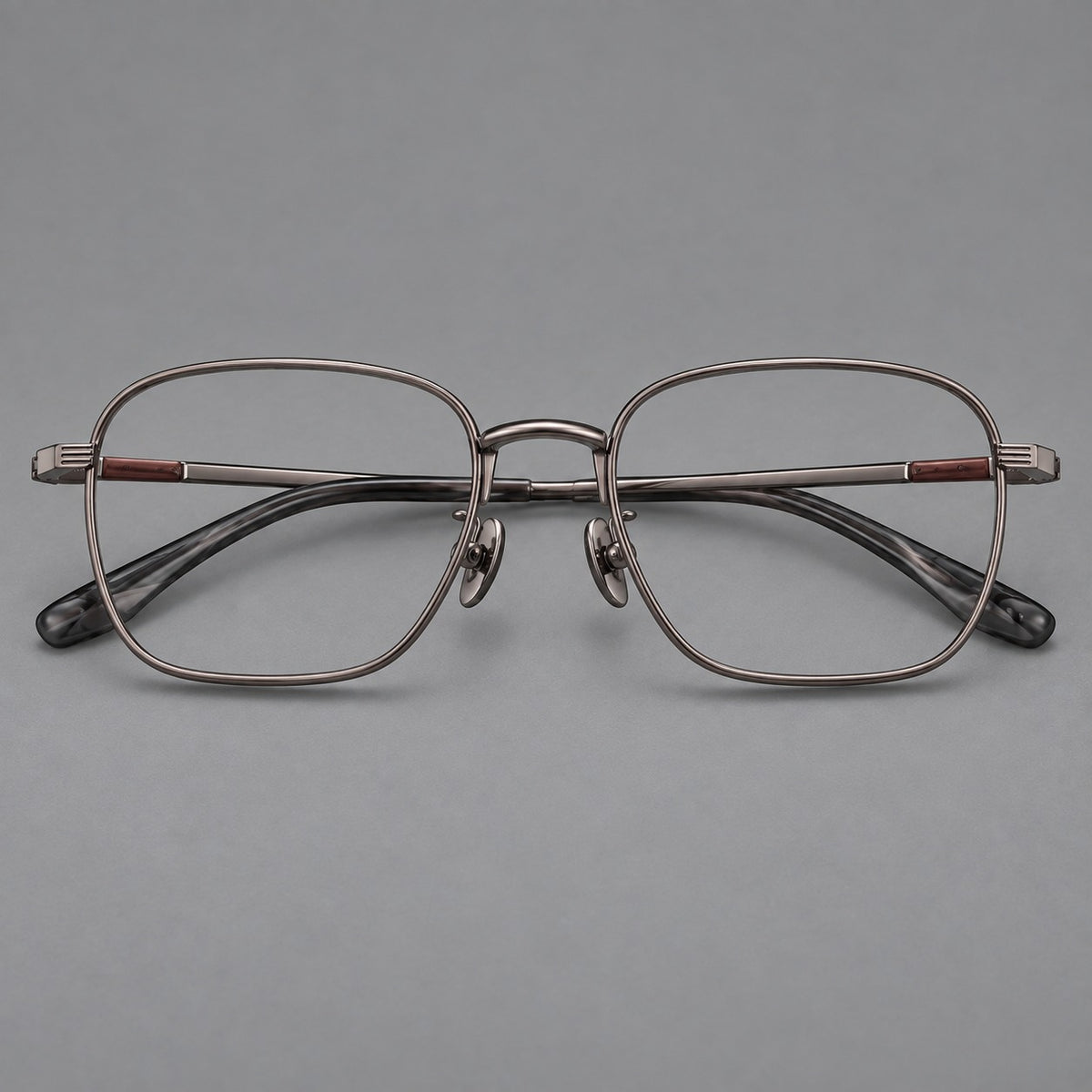 Deep square titanium glasses with a flatter brow and grooved outer shoulders in Gunmetal, front view