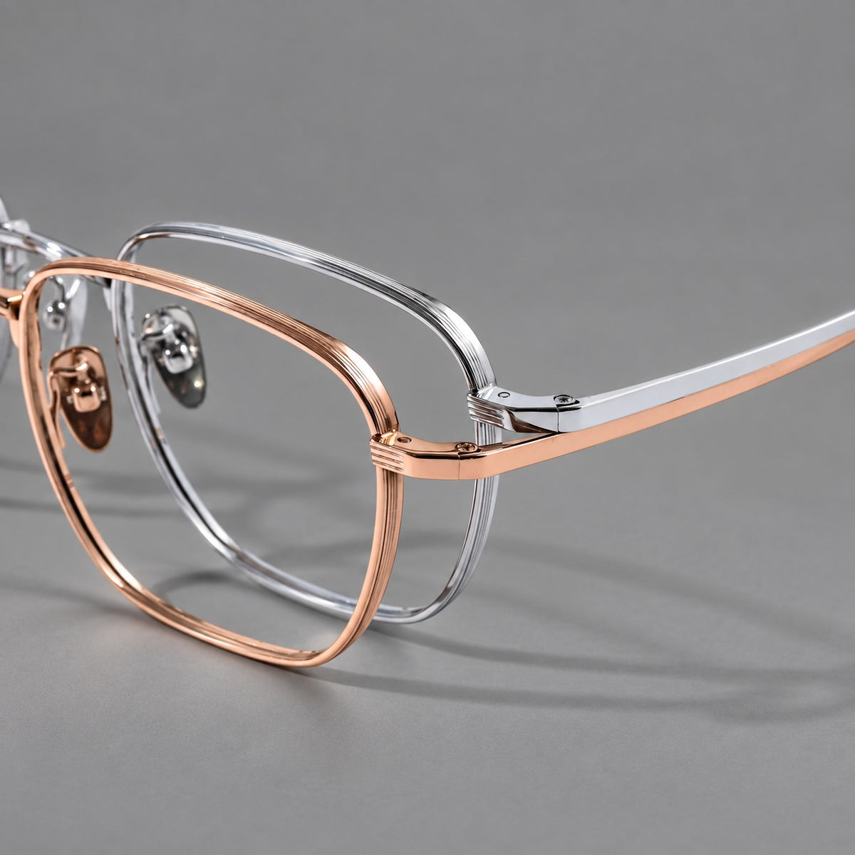 Deep square titanium glasses with a flatter brow and grooved outer shoulders, frame details