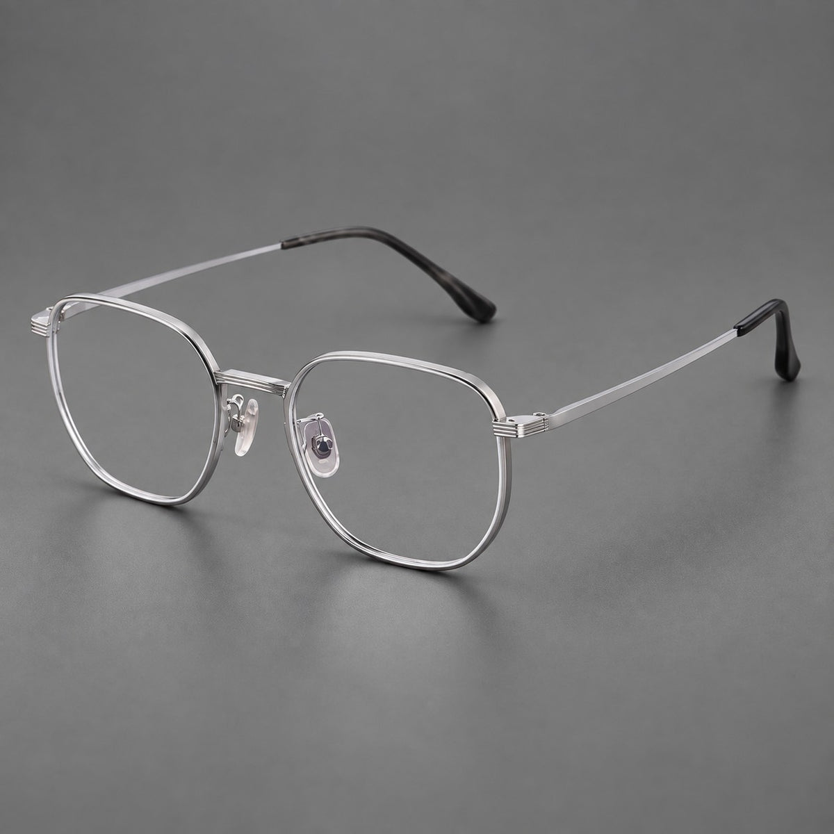 Geometric titanium glasses with flattened corners and a finely ridged bridge in Silver, three quarter view