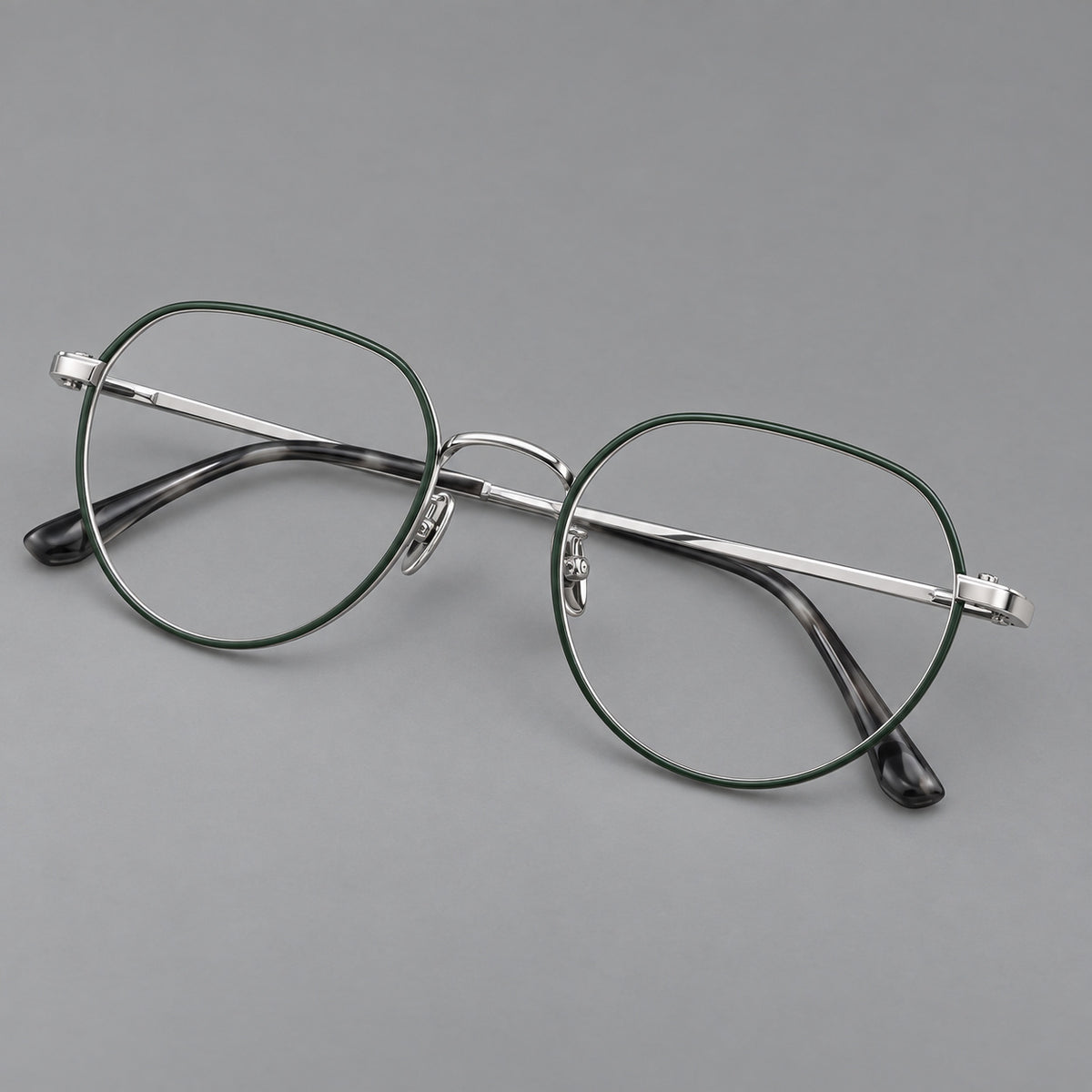 Classic panto titanium glasses with a curved bridge and slim straight temples in Dark Green and Silver, three quarter view