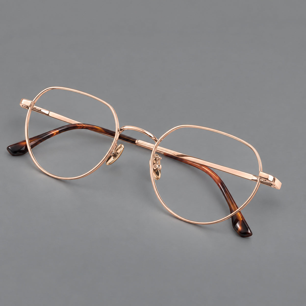 Classic panto titanium glasses with a curved bridge and slim straight temples in Rose Gold, three quarter view