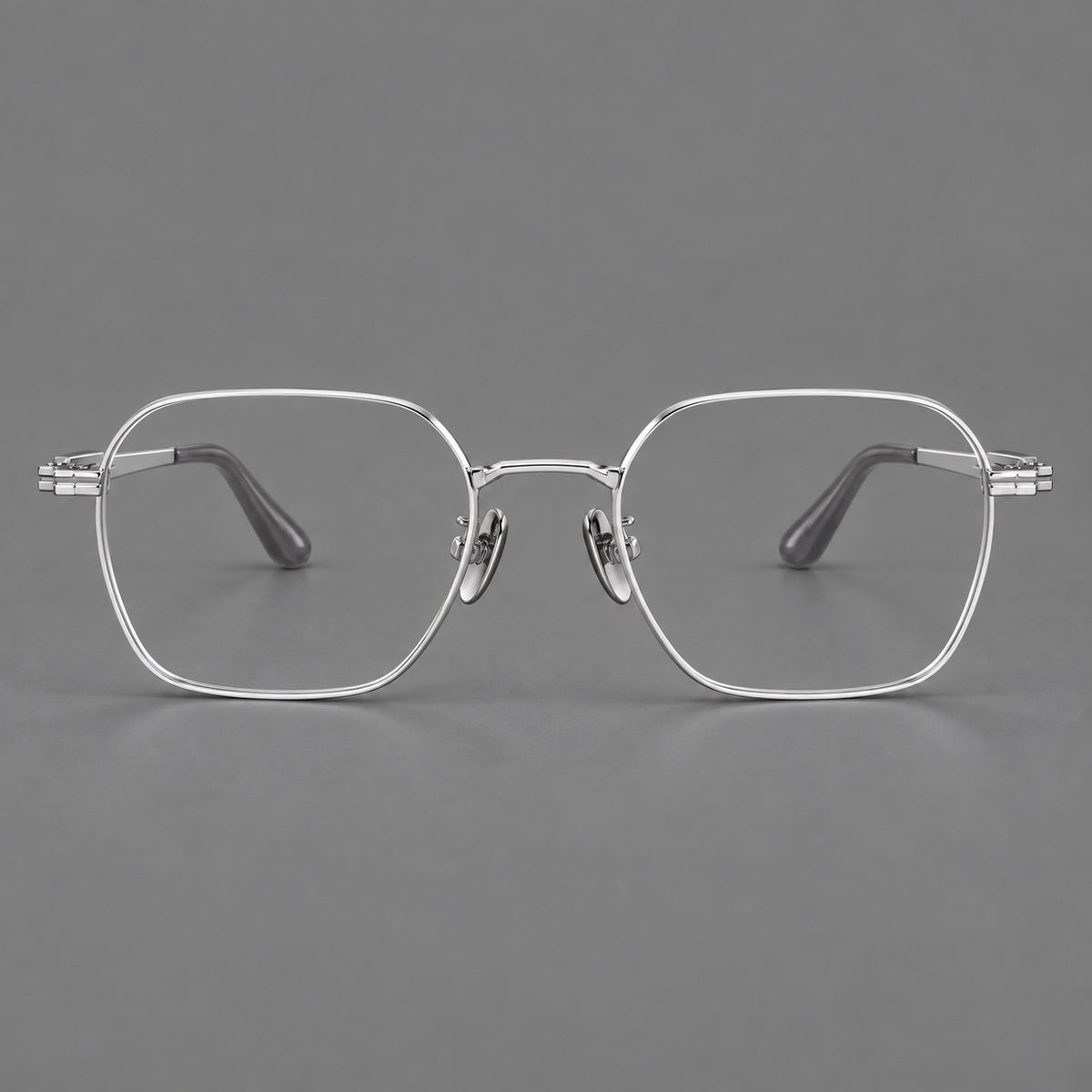 Soft square titanium glasses with an angular bridge and layered corner details in Silver, front view