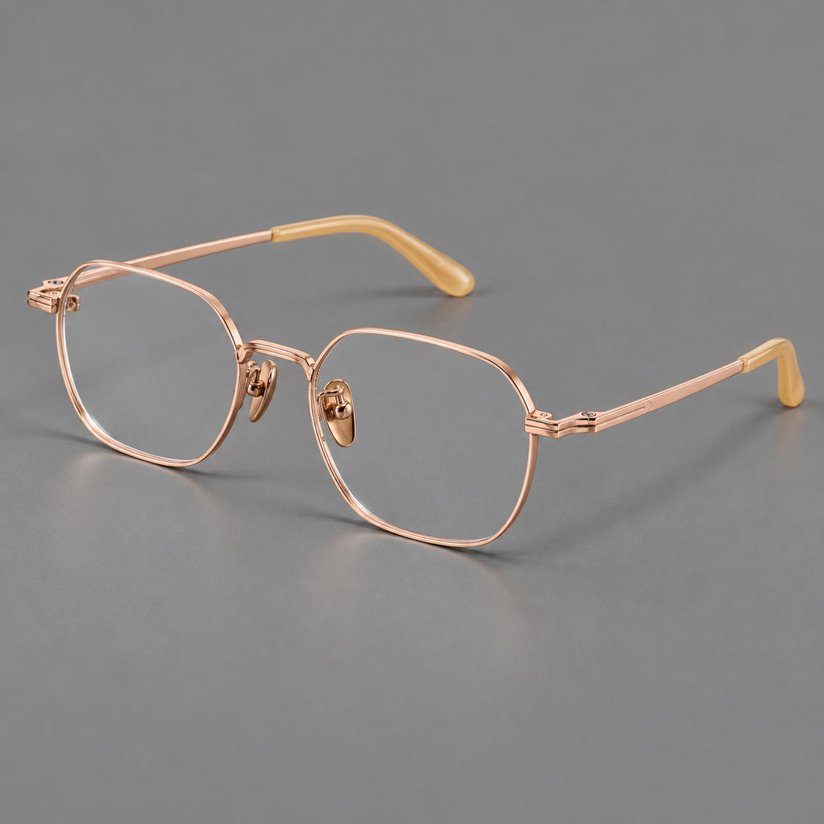 Soft square titanium glasses with an angular bridge and layered corner details in Rose Gold, three quarter view