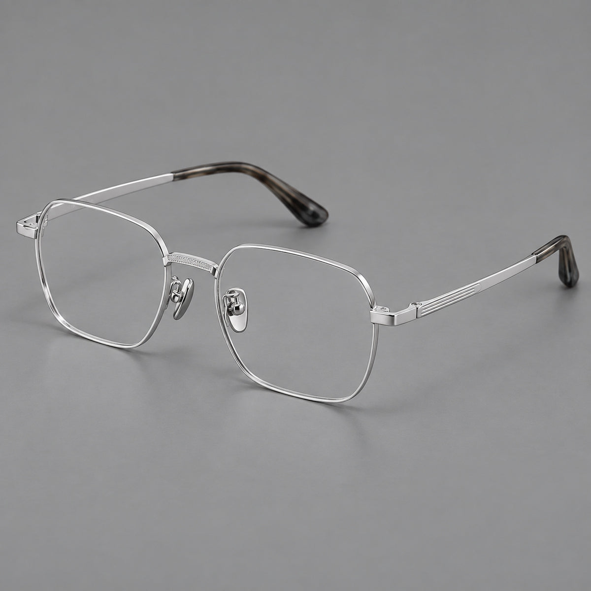 Geometric square titanium glasses with a textured bridge and fine temple grooves in Silver, three quarter view