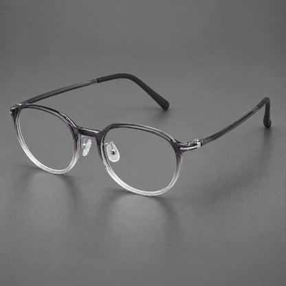 Retro round plastic eyeglasses with a curved bridge and slim metal corner accents in Ink Grey Gradient, three quarter view front view