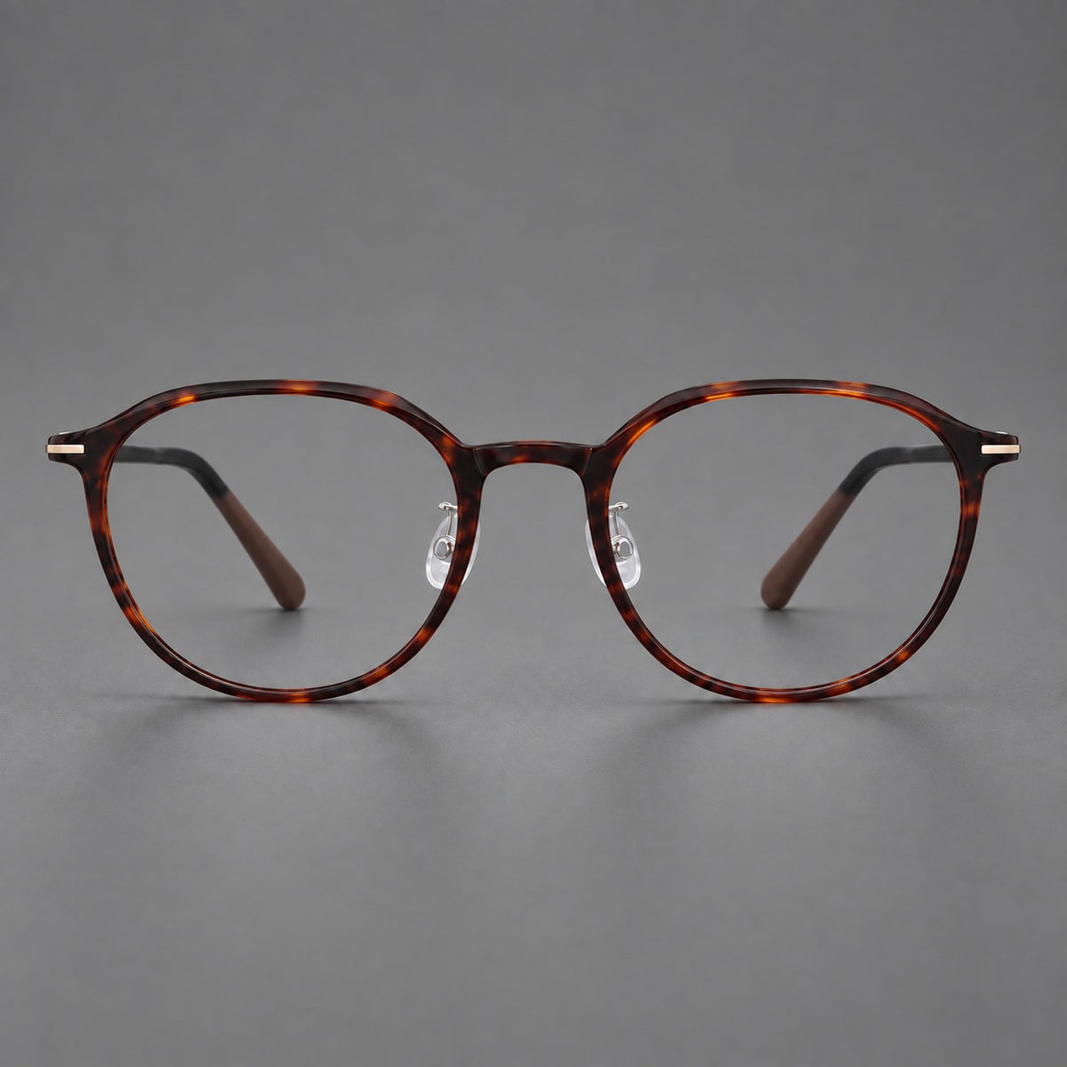 Retro round plastic eyeglasses with a curved bridge and slim metal corner accents in Tortoiseshell, front view