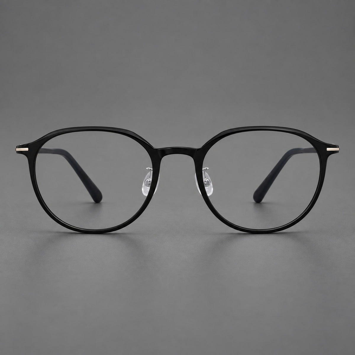 Retro round plastic eyeglasses with a curved bridge and slim metal corner accents in Glossy Black, front view