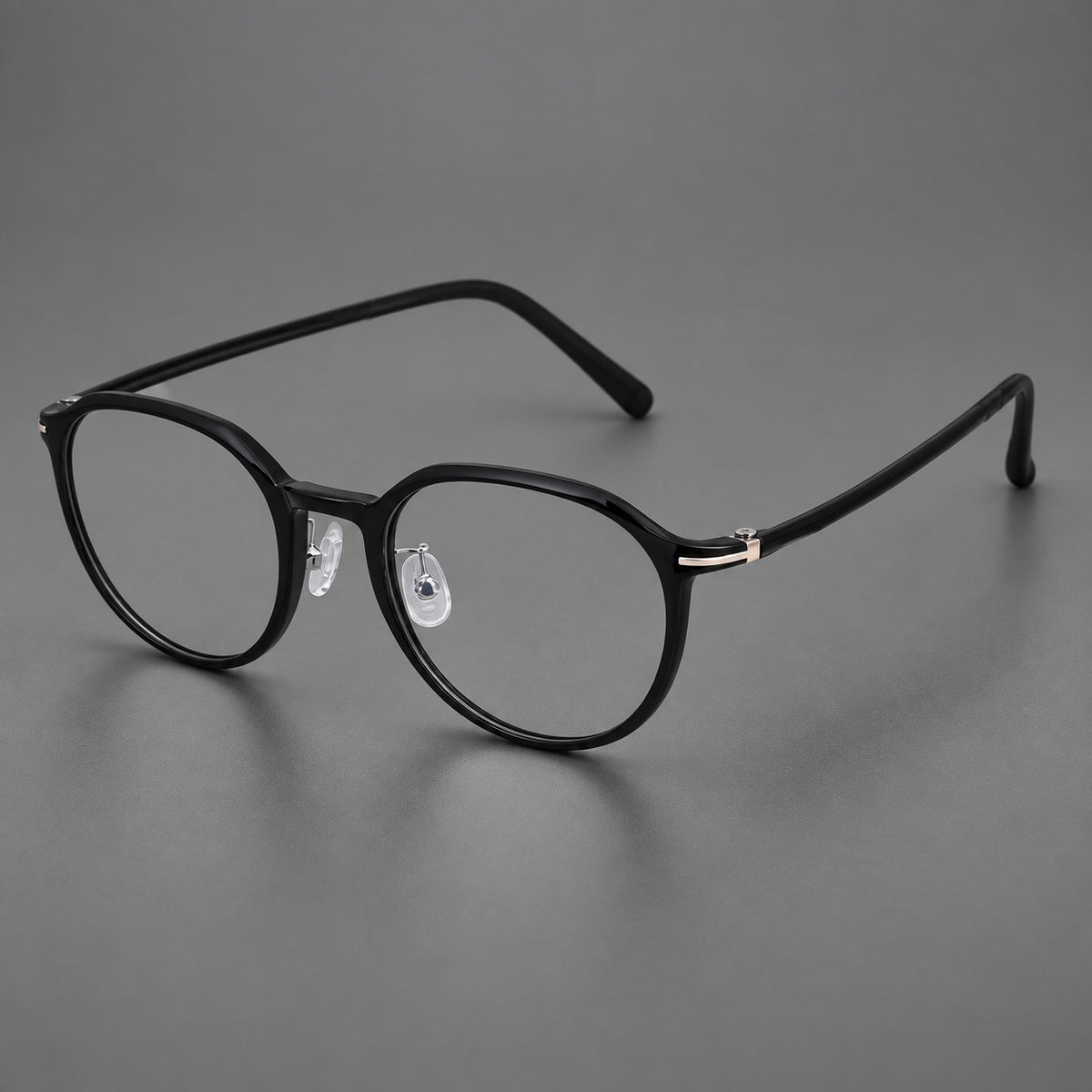 Retro round plastic eyeglasses with a curved bridge and slim metal corner accents in Glossy Black, three quarter view