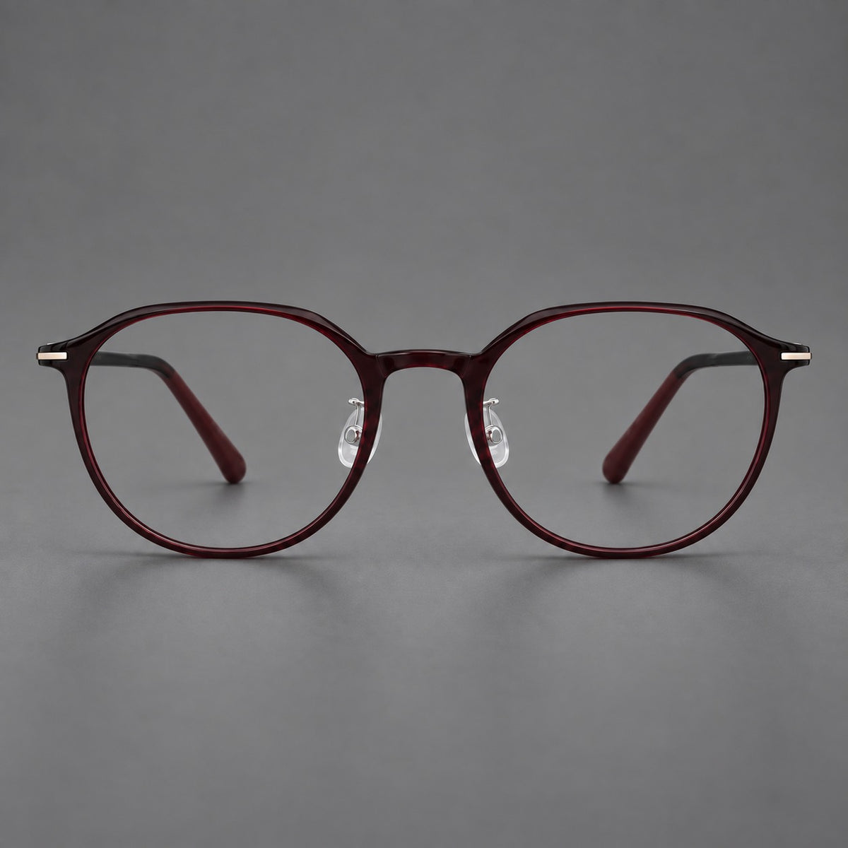 Retro round plastic eyeglasses with a curved bridge and slim metal corner accents in Deep Wine Red, front view