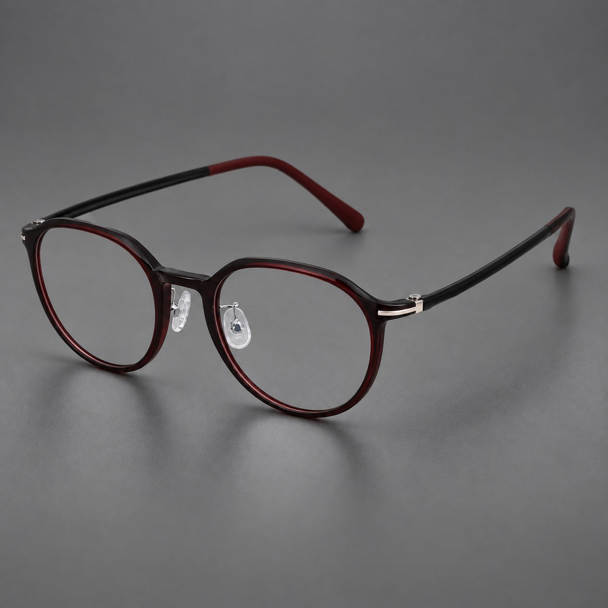 Retro round plastic eyeglasses with a curved bridge and slim metal corner accents in Deep Wine Red, three quarter view