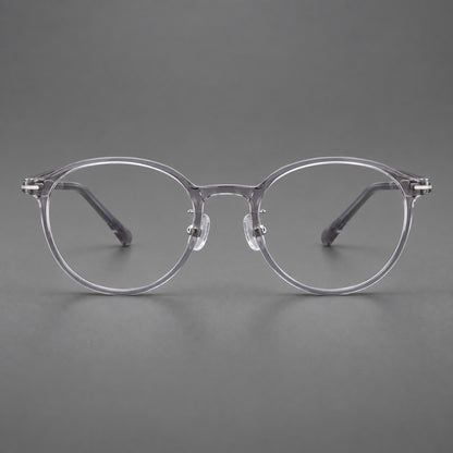 Compact round plastic eyeglasses with gently lifted corners and clear nose pads in Clear Grey, front view frame detail