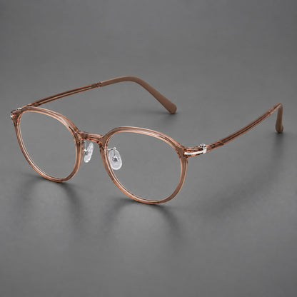 Compact round plastic eyeglasses with gently lifted corners and clear nose pads in Amber Tea, three quarter view lens detail