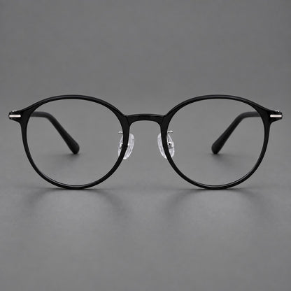 Compact round plastic eyeglasses with gently lifted corners and clear nose pads in Glossy Black, front view side view