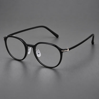 Compact round plastic eyeglasses with gently lifted corners and clear nose pads in Glossy Black, three quarter view