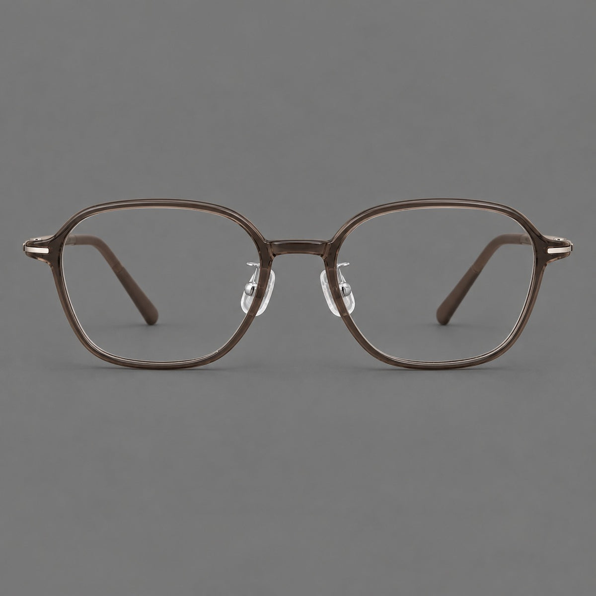 Rounded geometric plastic eyeglasses with softly angled rims and a curved bridge in Ink Brown, front view