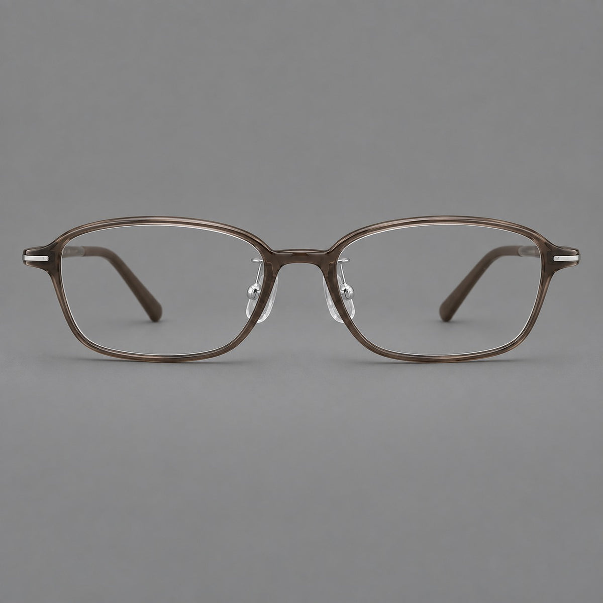 Soft oval plastic eyeglasses with a narrow bridge and gently rounded outer corners in Ink Brown, front view