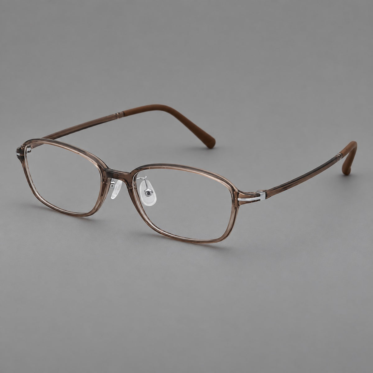 Soft oval plastic eyeglasses with a narrow bridge and gently rounded outer corners in Ink Brown, three quarter view