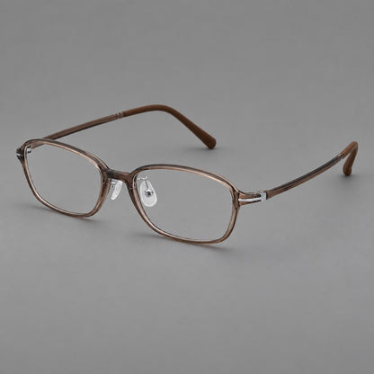 Soft oval plastic eyeglasses with a narrow bridge and gently rounded outer corners in Ink Brown, three quarter view lens detail