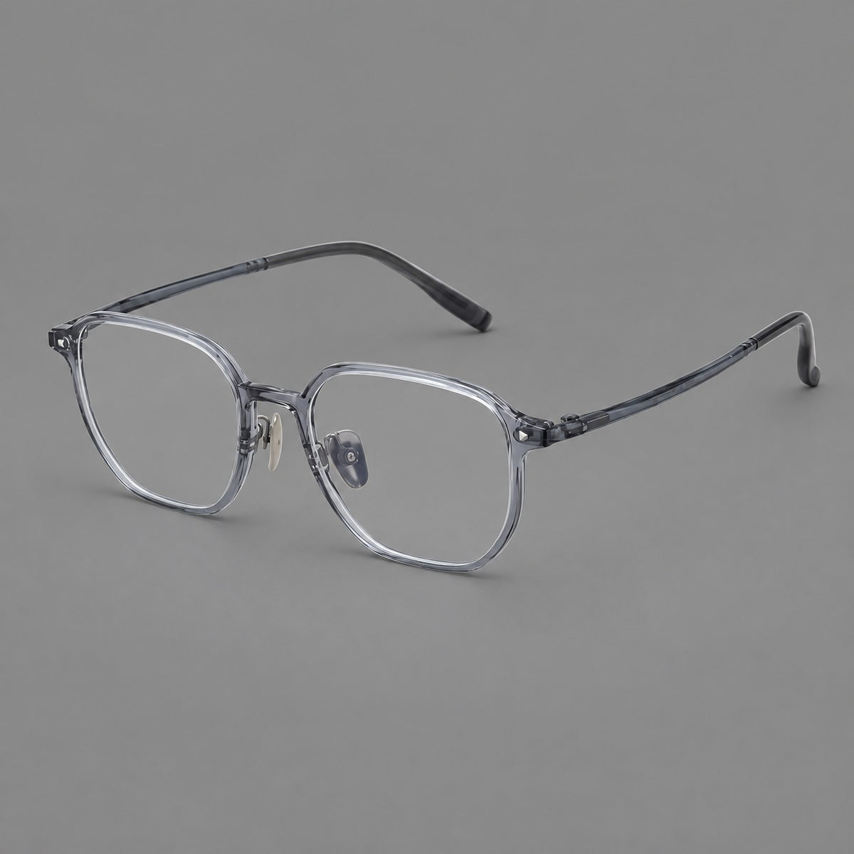 Soft square plastic eyeglasses with rounded lower rims and a broad curved bridge in Ink Grey, three quarter view