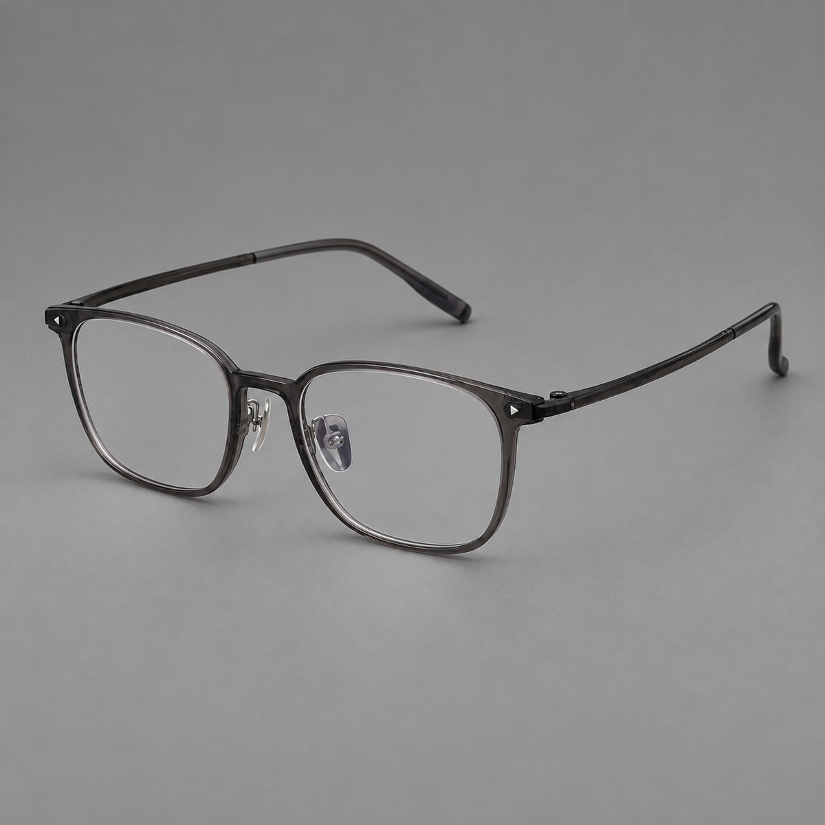 Classic soft square plastic eyeglasses with a gently curved browline and corner studs in Dark Grey, three quarter view