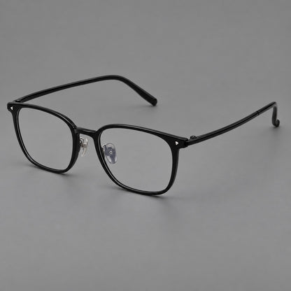Classic soft square plastic eyeglasses with a gently curved browline and corner studs in Glossy Black, three quarter view