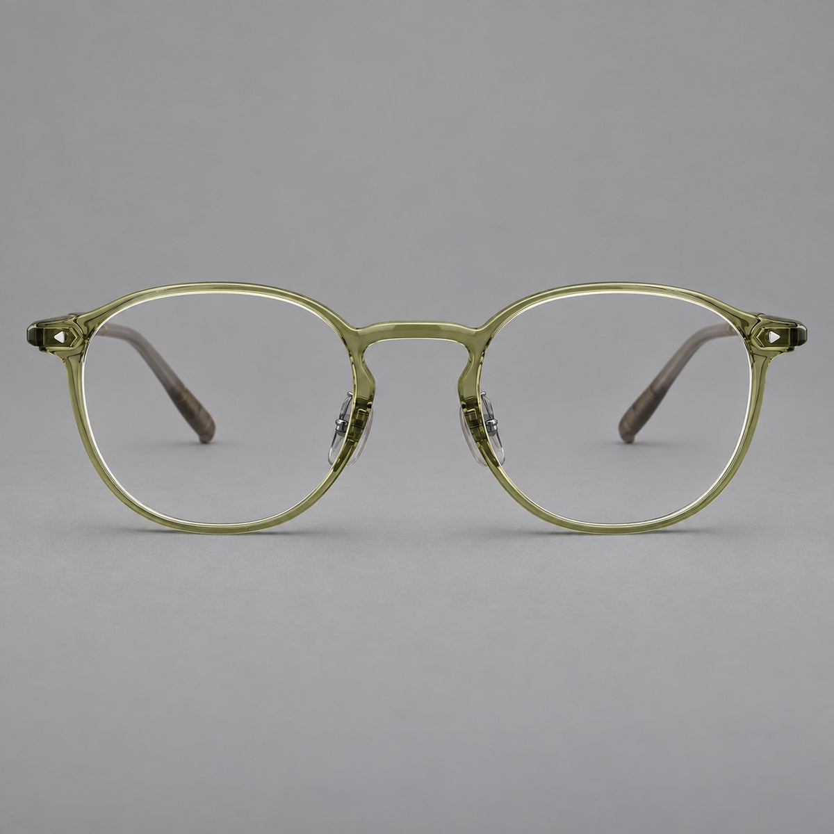 Vintage round plastic eyeglasses with a curved bridge and subtle triangular accents in Light Green, front view
