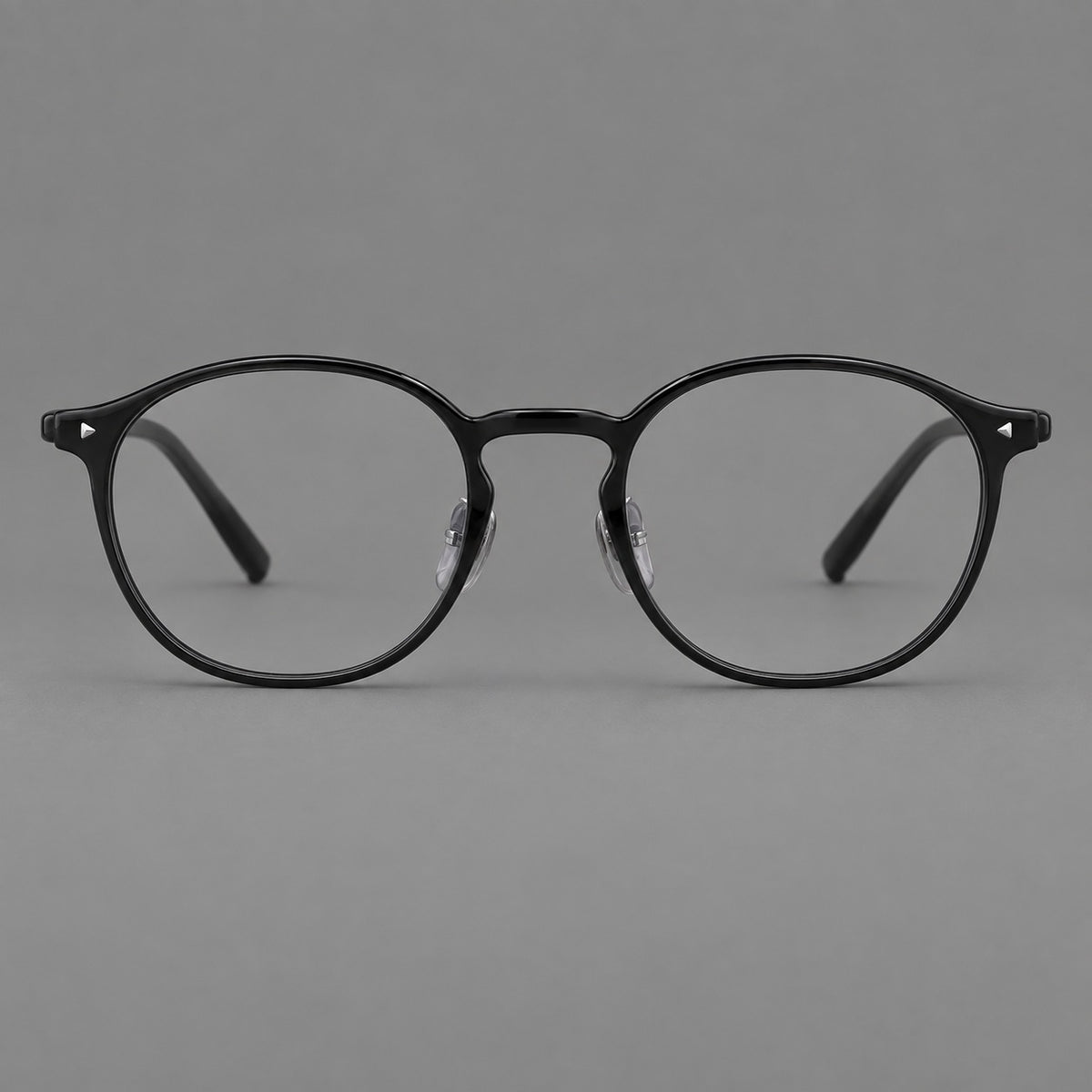 Vintage round plastic eyeglasses with a curved bridge and subtle triangular accents in Glossy Black, front view