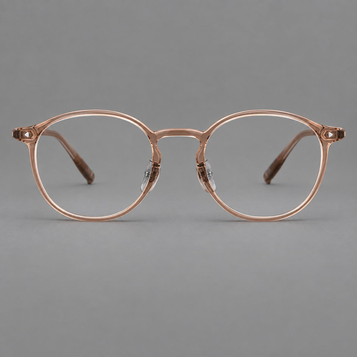 Vintage round plastic eyeglasses with a curved bridge and subtle triangular accents in Tea, front view