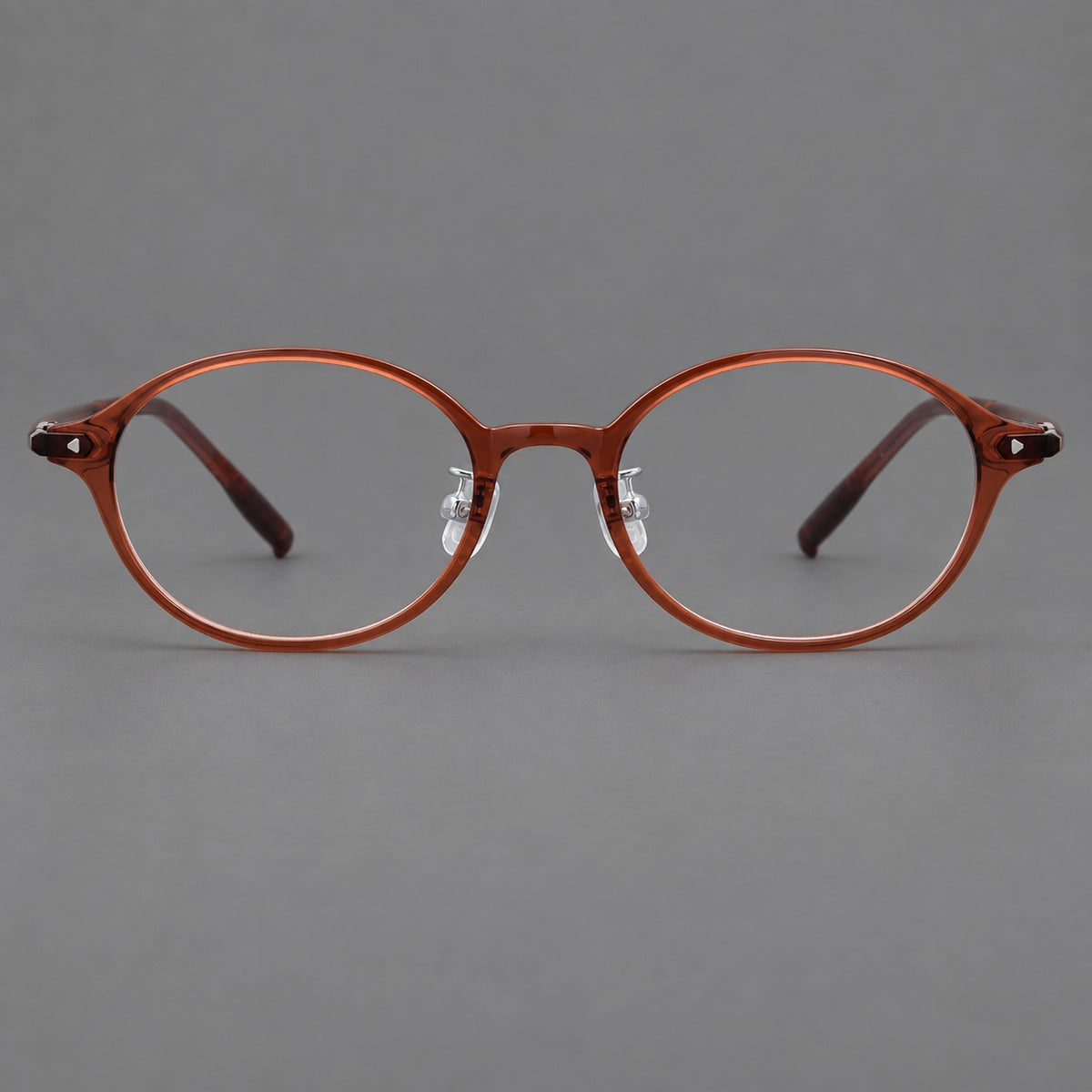 Retro round plastic eyeglasses with softly lifted corners and a sculpted bridge in Brown Red, front view