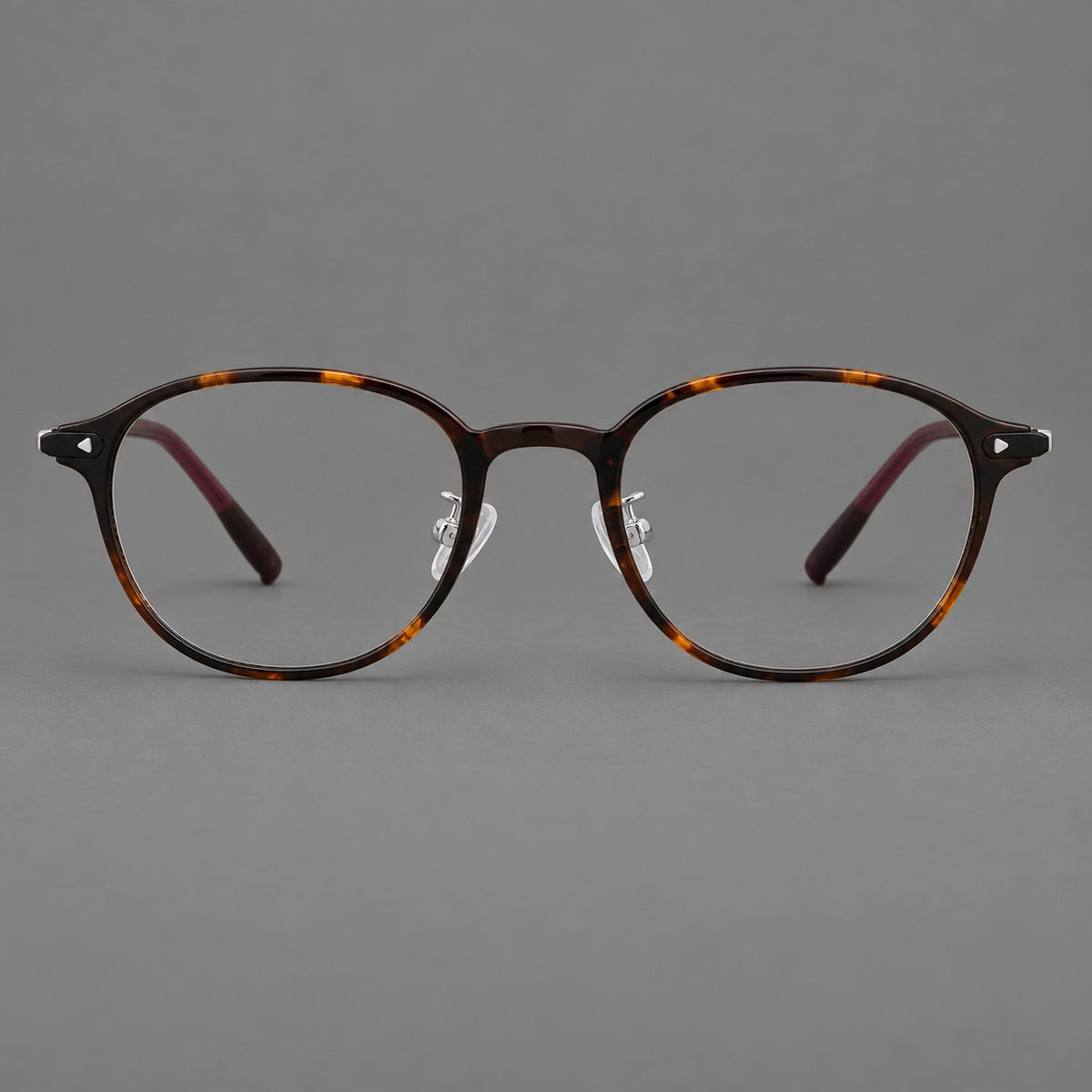 Panto plastic eyeglasses with a rounded silhouette and triangular corner studs in Tortoiseshell, front view