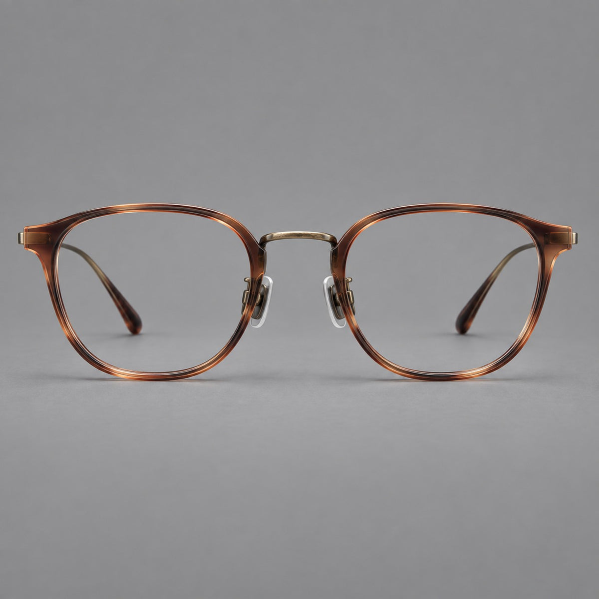 Retro soft square eyeglasses in acetate and titanium with a curved bridge and slender temples in Amber Tortoiseshell / Antique Gold, front view