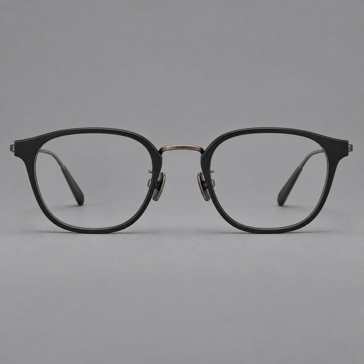 Retro soft square eyeglasses in acetate and titanium with a curved bridge and slender temples in Matte Black / Antique Copper, front view