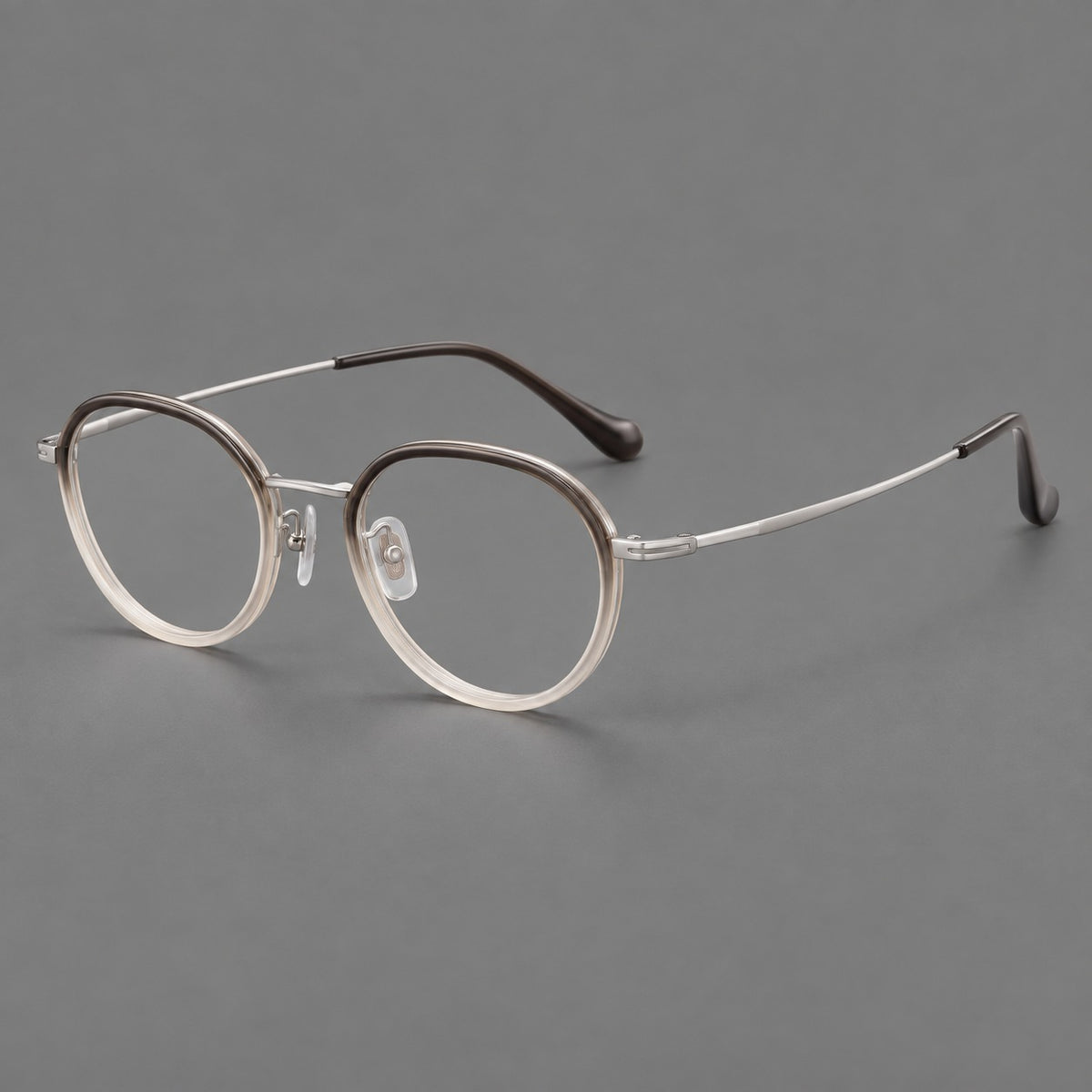 Rounded eyeglasses in acetate and titanium with gently arched brows and engraved metal temples in Mist Grey Gradient / Silver, three quarter view